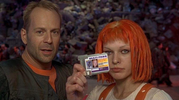 Bruce Willis and Milla Jovovich as their characters in The Fifth Element stand side by side. Jovovich holds up an ID card.