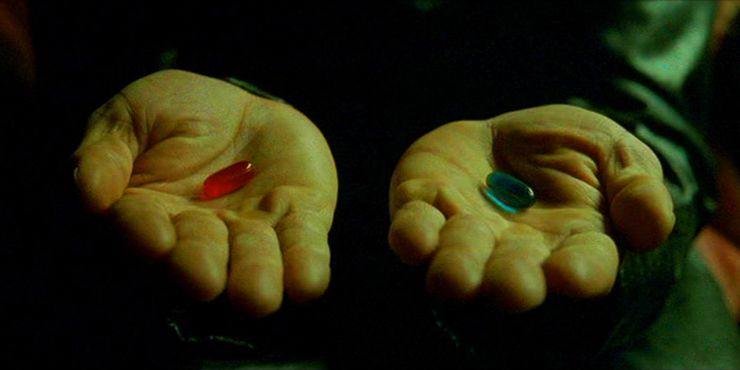 two hands held out in a black background, one holds a red pill and the other a blue pill